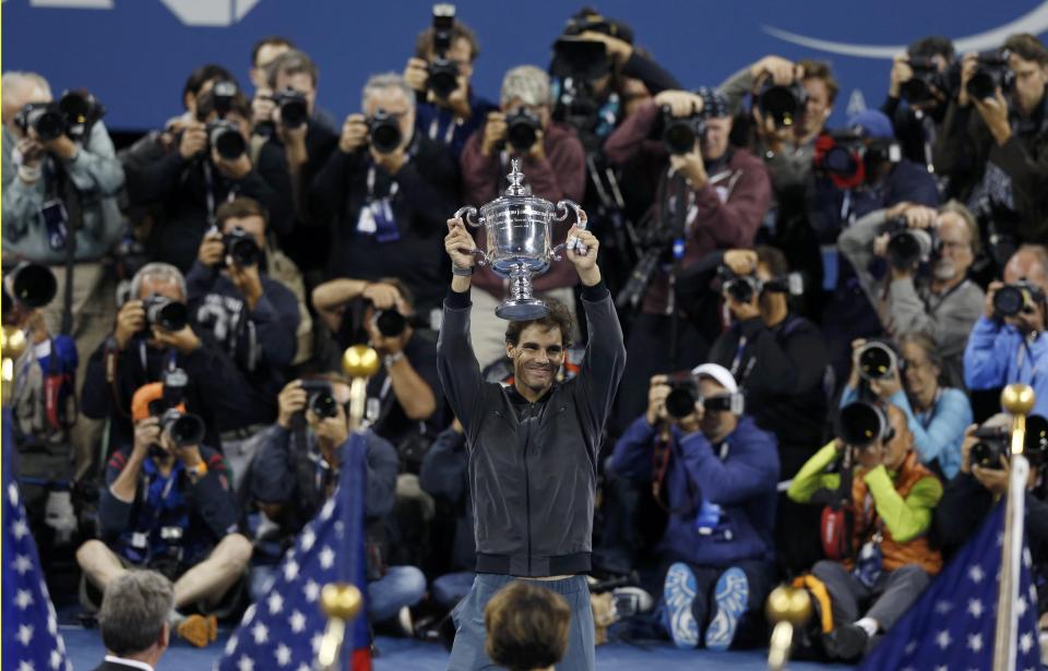 Nadal of Spain raises his trophy after defeating Djokovic of Serbia in their men's final match at the U.S. Open tennis championships in New York