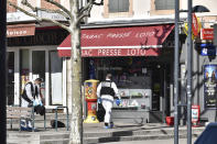 Police officers investigate after a man wielding a knife attacked residents venturing out to shop in the town under lockdown, Saturday April 4, 2020 in Romans-sur-Isere, southern France. The alleged attacker was arrested by police nearby, shortly after the attack. Prosecutors did not identify him. They said he had no documents but claimed to be Sudanese and to have been born in 1987. (AP Photo)