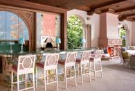 <p>This ultra-feminine outdoor space in a family's Florida beach home is an idyllic spot to lounge, drink, and dine year-round. Designer <a href="https://lorimorris.com/" rel="nofollow noopener" target="_blank" data-ylk="slk:Lori Morris;elm:context_link;itc:0;sec:content-canvas" class="link ">Lori Morris</a> custom-designed the Italian floral mosaic tile and equipped the patio with every amenity a hostess could dream of. A glass chiller, ice maker, dishwasher, and several refrigerator drawers ensure you never have to miss a bit (or go back inside!) when hosting an intimate or large group.</p>