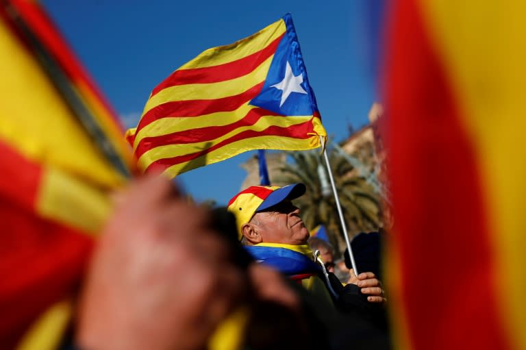 Independence supporters held Catalan separatist flags outside parliament