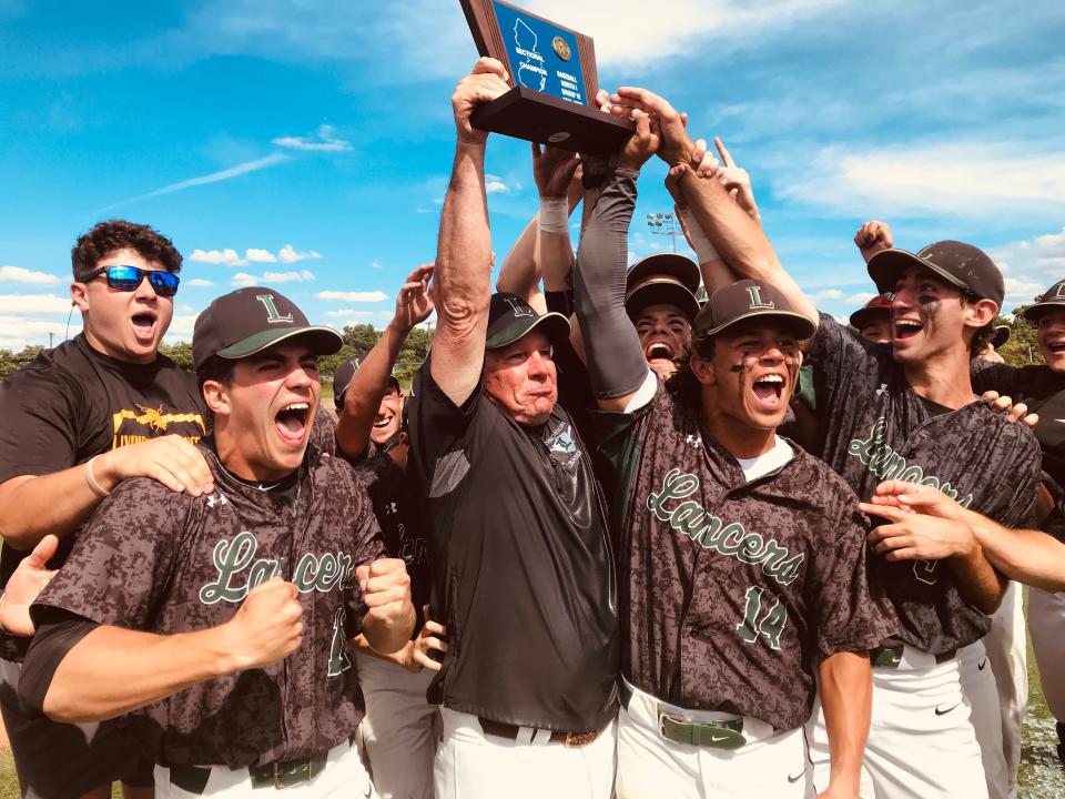 Livingston baseball coach Mickey Ennis lifts the North 1, Group 4 baseball title after his team's win over Passaic Tech. June 10, 2022.