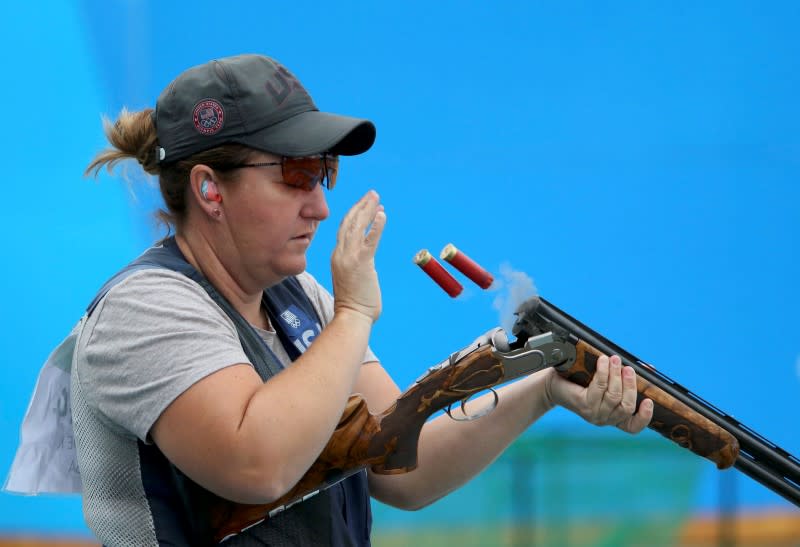 Kim Rhode discharges shells from her rifle duing woman's skeet qualifications. (Reuters)