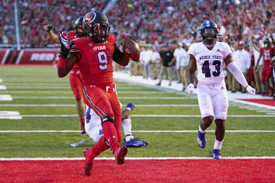 Utah running back Tavion Thomas (9) scores a touchdown during the first half of the team's NCAA college football game against Weber State on Thursday, Sept. 2, 2021, in Salt Lake City. (AP Photo/Rick Bowmer)