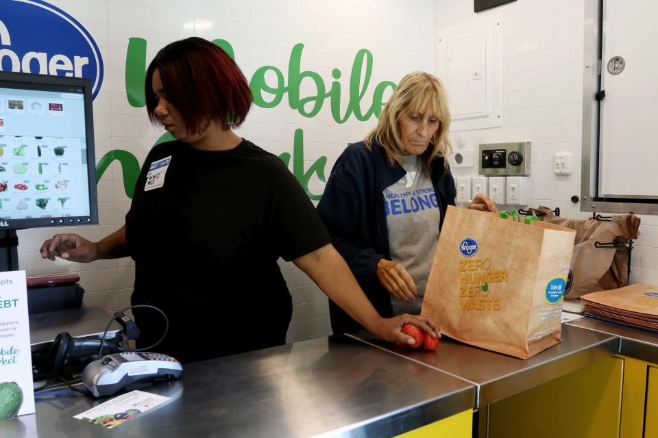 Employees ring up groceries at the Zero Hunger Mobile Market in Louisville, Kentucky. The market is a partnership between Kroger and Dare to Care Food Bank.