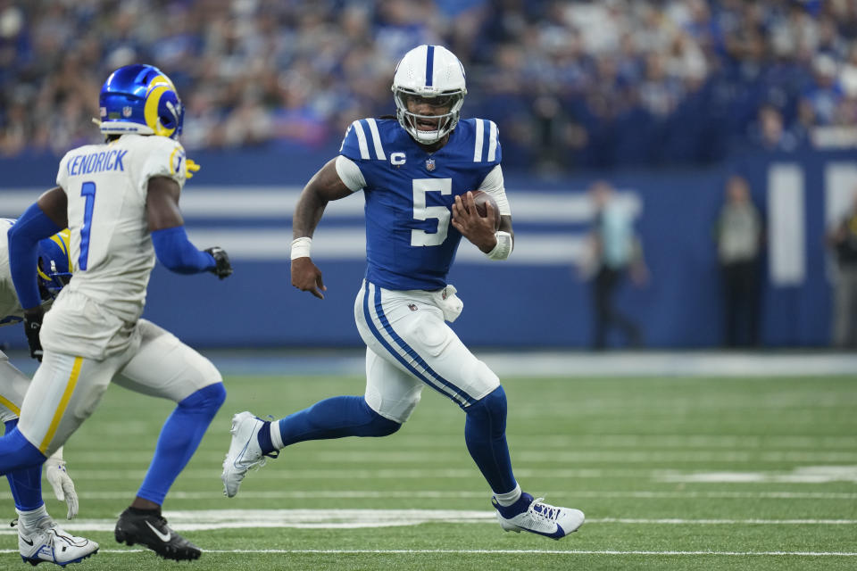 Indianapolis Colts quarterback Anthony Richardson (5) scrambles as Los Angeles Rams cornerback Derion Kendrick (1) defends during the first half of an NFL football game, Sunday, Oct. 1, 2023, in Indianapolis. (AP Photo/Michael Conroy)