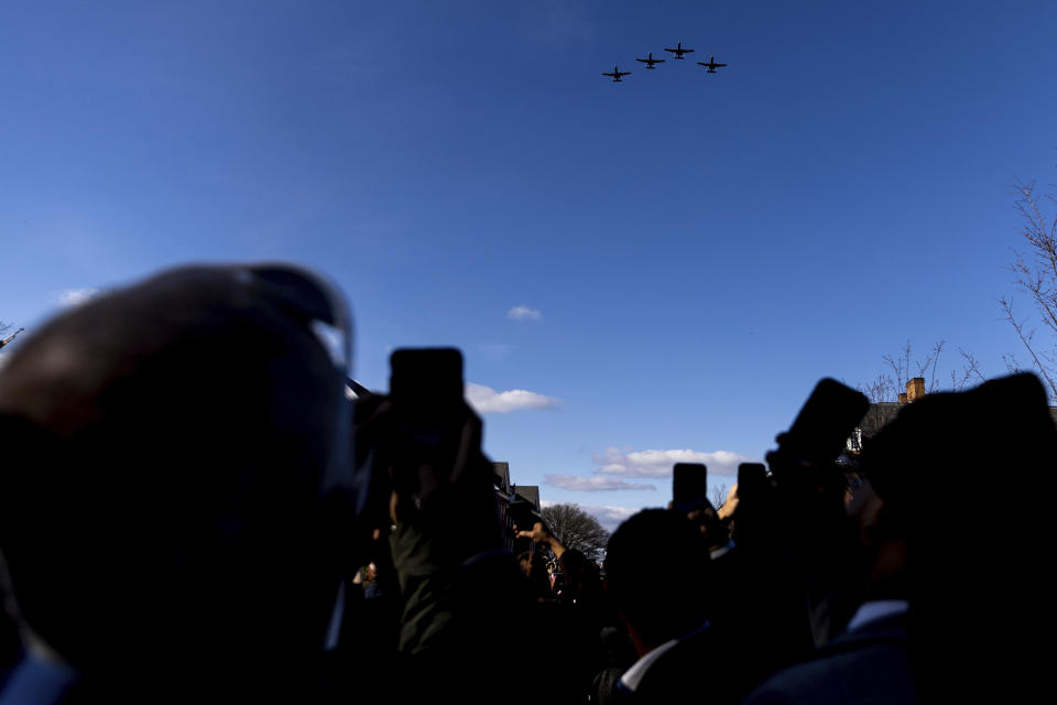 People photograph the Air National Guard 104th Fighter Squadron's flyover during Maryland Gov. Wes Moore's inauguration, Wednesday, Jan. 18, 2023, in Annapolis, Md. (AP Photo/Julia Nikhinson)