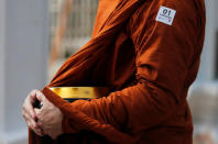 A sticker for people who have been under security checking is seen on a Buddhist monk at the Kelaniya Buddhist temple during Vesak Day, commemorating the birth, enlightenment and death of Buddha, in Colombo, Sri Lanka May 18, 2019. REUTERS/Dinuka Liyanawatte