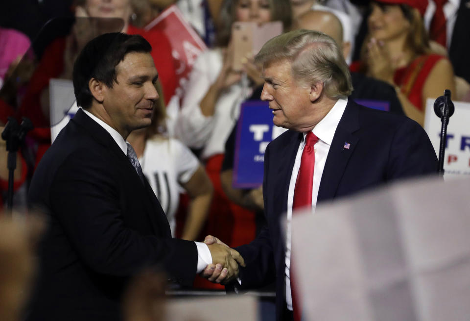 President Donald Trump shakes hands with DeSantis during a rally in Tampa, Fla., in July 2018.