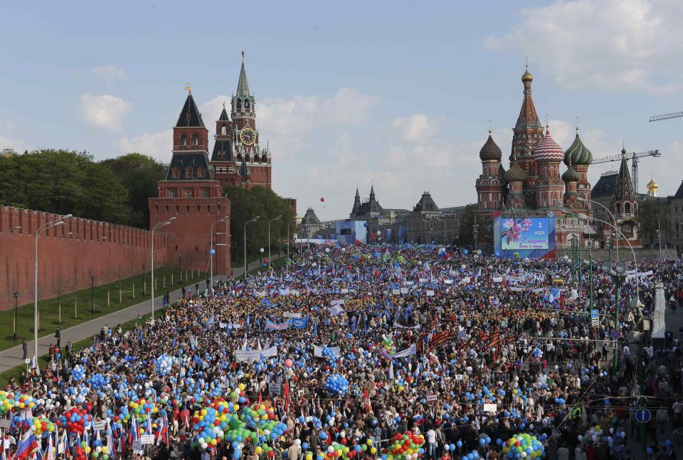 People walk with flags and balloons towards St. Basil's Cathedral on Red Square during a rally in Moscow May 1, 2014. Russians celebrate the coming of Spring and since communist times, Labour Day on the first day of May. (REUTERS/Maxim Shemetov)