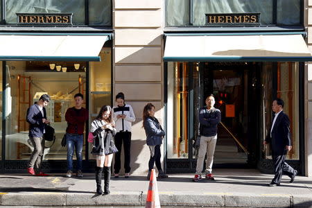 Customers queue up as they wait the opening of the main shop of French luxury group Hermes in Paris, France, September 23, 2015. REUTERS/Charles Platiau