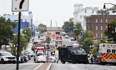Police block off the M Street, SE, as they respond to a shooting at the Washington Navy Yard in Washington, September 16, 2013. The U.S. Navy said several people were injured and there were possible fatalities in the shooting at the Navy Yard in Washington D.C. on Monday. The Navy did not immediately provide additional details but a Washington police spokesman said earlier that five people had been shot, including a District of Columbia police officer and one other law enforcement officer. REUTERS/Joshua Roberts