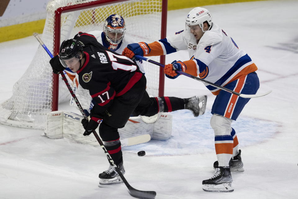 New York Islanders defenseman Samuel Bolduc clears Ottawa Senators' Ridly Greig from in front of goaltender Semyon Varlamov during the first period of NHL hockey game, Wednesday, Jan. 25, 2023 in Ottawa, Ontario. (Adrian Wyld/The Canadian Press via AP)