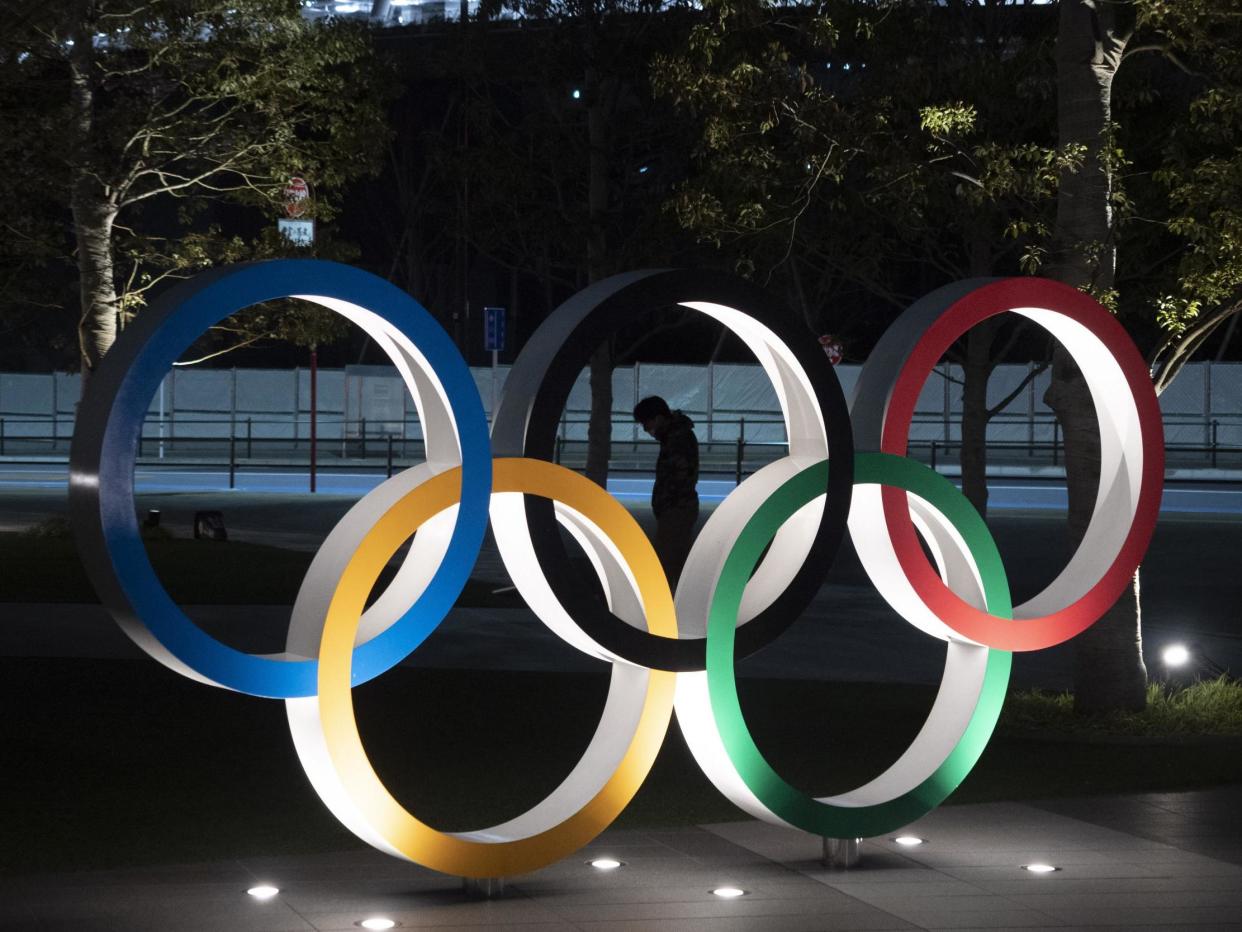 A man is seen through the Olympic rings: AP