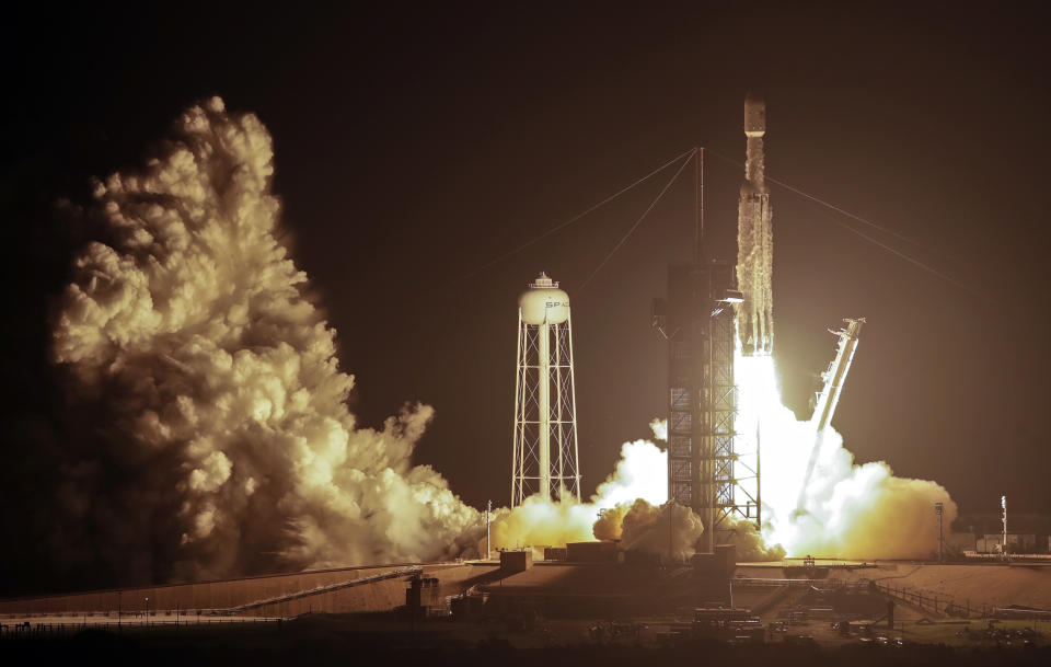A SpaceX Falcon heavy rocket lifts off from pad 39A at the Kennedy Space Center in Cape Canaveral, Fla., early Tuesday, June 25, 2019. The Falcon rocket has a payload military and scientific research satellites. (AP Photo/John Raoux)