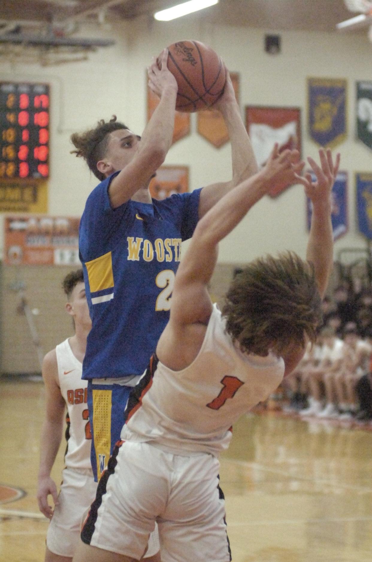 Wooster's Micah McKee and Ashland High School's Landon McFrederick (1) during basketball action at Arrow Arena Friday, Jan. 28, 2022.