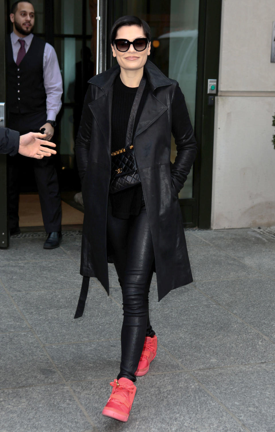 Jessie J walks down the street in faux leather leggings and sunglasses