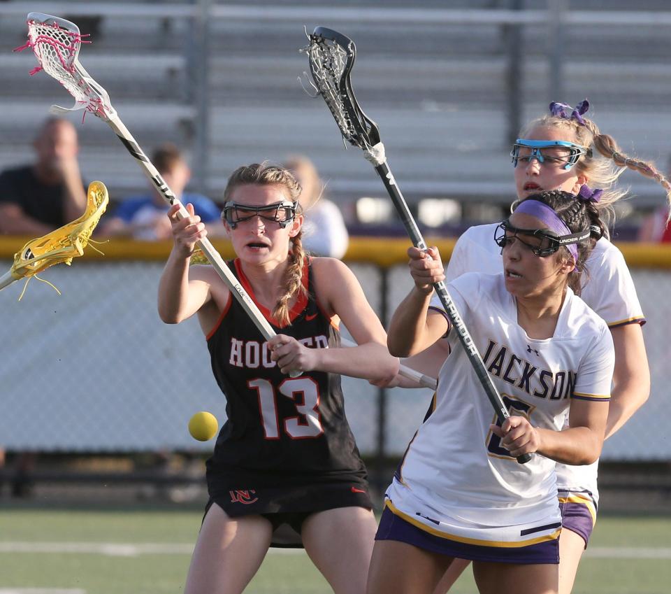 Madison Vardavas, left, of Hoover and Catalina Gonzalez, right, of Jackson fight for the ball during their game at Jackson on Tuesday, May 10, 2022.