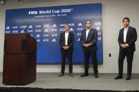 Colin Smith, FIFA Chief Tournaments & Events Officer, left, Victor Montagliani, FIFA vice-president and CONCACAF president, center, and Dan Corso, president of Atlanta Sports Council, listen to a question during a press conference, Friday afternoon, Sept. 17, 2021 at Mercedes-Benz Stadium in Atlanta. Officials were touring the stadium as part of the FIFA World Cup 2026 Candidate Host City Tour. (AP Photo/Ben Gray)