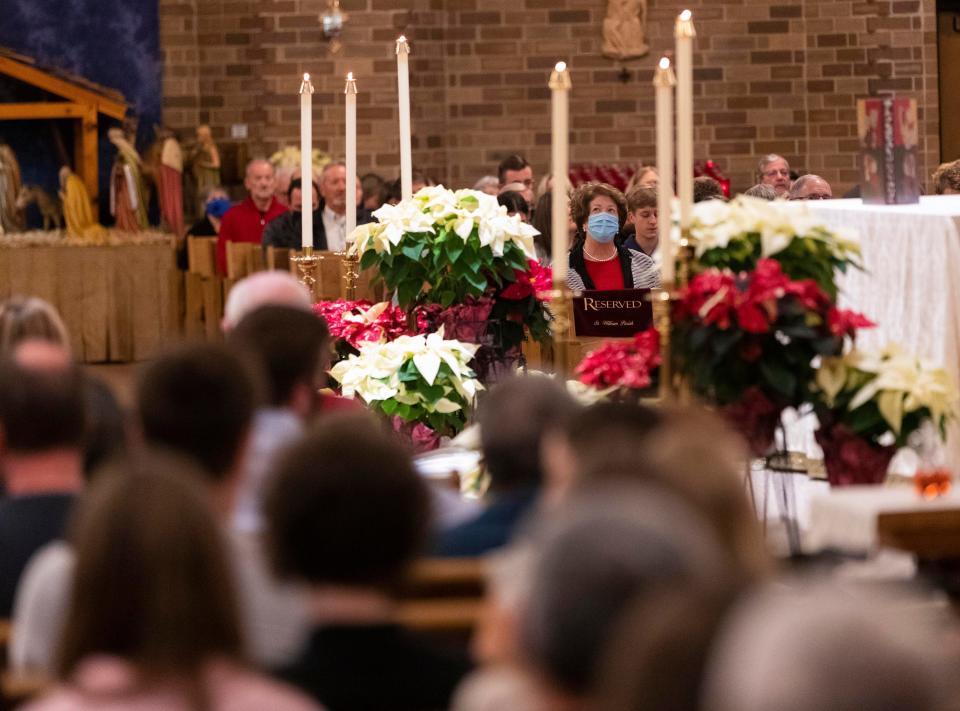 Worshippers attend Christmas Eve mass Friday, December 24, 2021 at St. William Catholic Church in Waukesha, Wis. St. William is one of four parishes that make up the “Catholic Community of Waukesha”. Several of their members were struck and seriously injured Nov. 21, when a man driving a red Ford Escape plowed into the city's annual Christmas parade, leaving six dead and more than 60 injured.