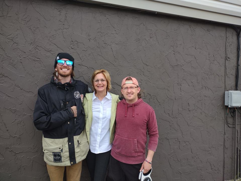From left, Christopher Gibson, Lisa Marie Tobin of the Gaylord Area Arts Council and Gaylord City Councilman Jordan Awrey stand in front of a wall on the MacNamara Insurance building that will be part of an enhancement project in a three-block area behind Main Street.