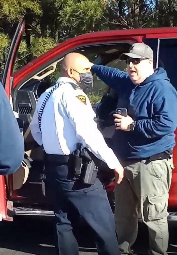 In this still photo from a video showing the aftermath of a deadly shooting Saturday, Jan. 8, 2022, Cumberland County Sheriff's Lt. Jeffrey Hash explains to a Fayetteville police officer what happened before he shot Jason Walker to death on Bingham Road on Saturday.