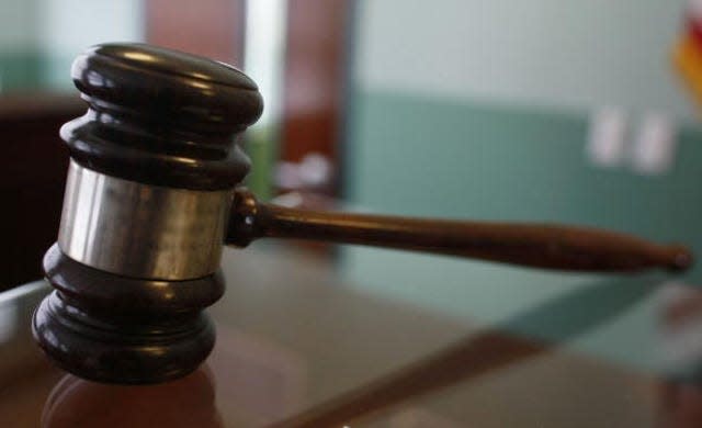 A judge's gavel rests on top of a desk