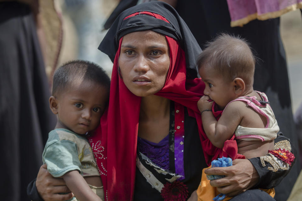 FILE - In this Oct. 22, 2017, file photo, Rohingya Muslim woman, Rukaya Begum, who crossed over from Myanmar into Bangladesh, holds her son Mahbubur Rehman, left and her daughter Rehana Bibi, after the government moved them to newly allocated refugee camp areas, near Kutupalong, Bangladesh. A special U.N. body has wrapped up two years of documenting alleged human rights violations by Myanmar's security forces with a call for the Southeast Asian nation be held responsible in international legal forums for genocide against the Muslim Rohingya minority. (AP Photo/Dar Yasin, File)