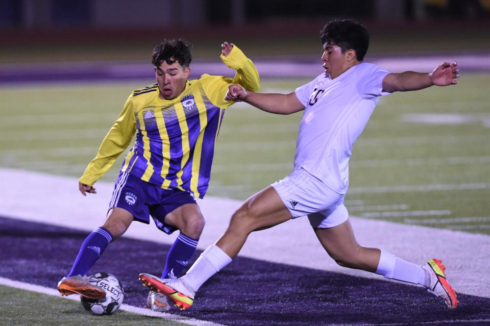 Wylie's Alen Canales (10) pulls the ball back away from a Brownwood defender during Tuesday's game. The Bulldogs lost 1-0.