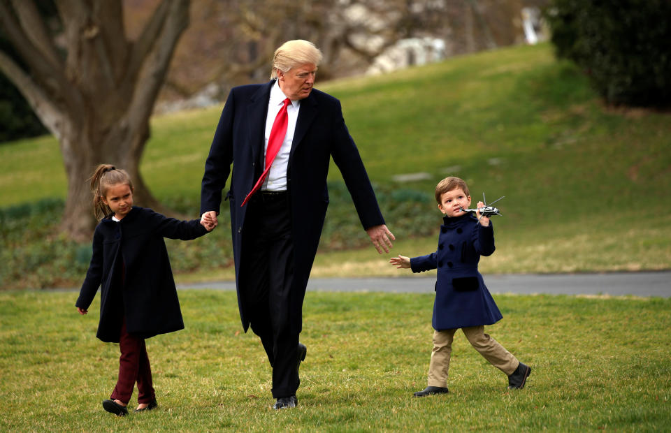 Joseph Kushner holds up a toy Marine One as his grandfather, Donald Trump, holds hands with him and his sister Arabella as they depart aboard Marine One from the White House in Washington on March 3, 2017.&nbsp;