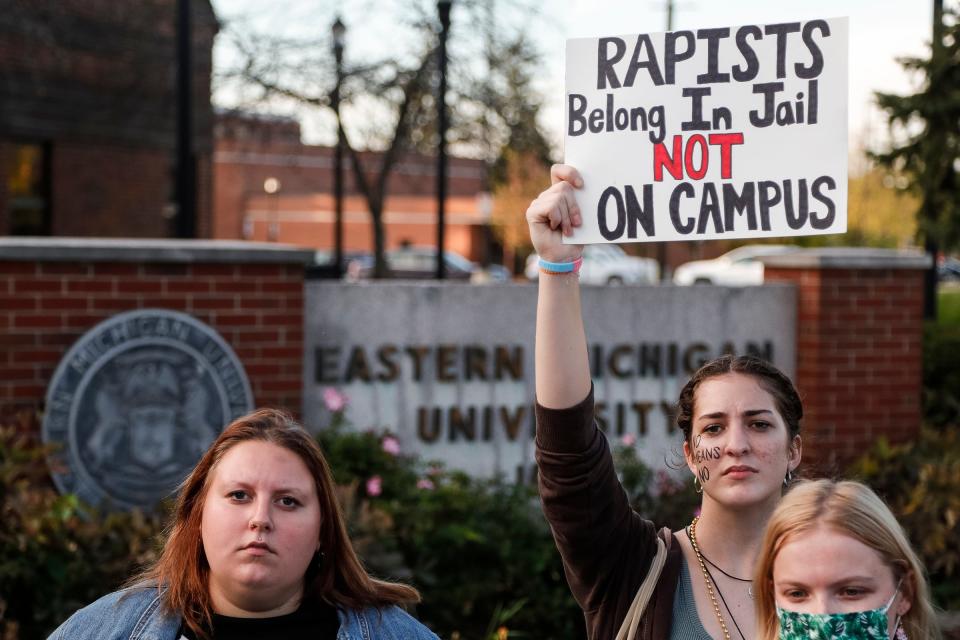 Eastern Michigan University student Taylor Malpass holds a sign that says, "Rapists belong in jail not on campus," during a protest against fraternities Alpha Sigma Phi and Delta Tau Delta in Ypsilanti on Oct. 19.