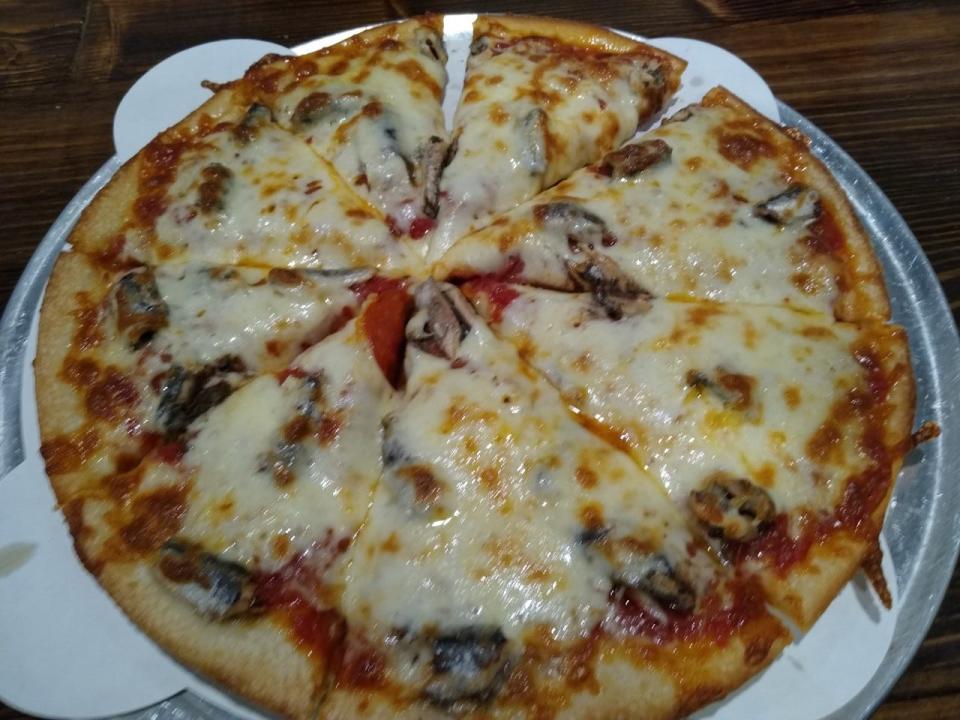 A medium pepperoni and anchovy pizza is served at the Pint and Pie Works in Bath Township. Thanks to a happy accident in the kitchen, it has double cheese, too.