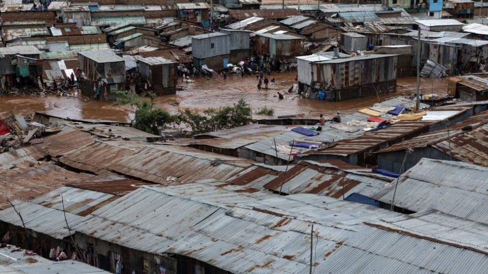 Residents of the Mathare slum try to save goods from their destroyed houses