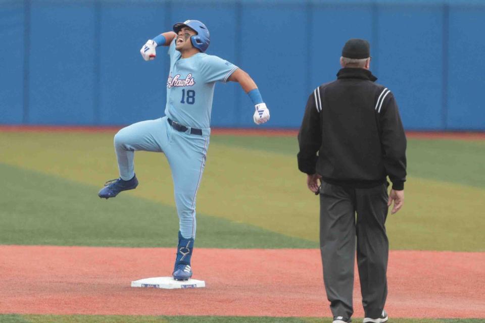 Kansas third baseman Kodey Shojinaga (18) exults over his three-run double during the Jayhawks' 7-3 victory Sunday over Texas Tech. Kansas swept the series, moving within three games of first place in the Big 12.