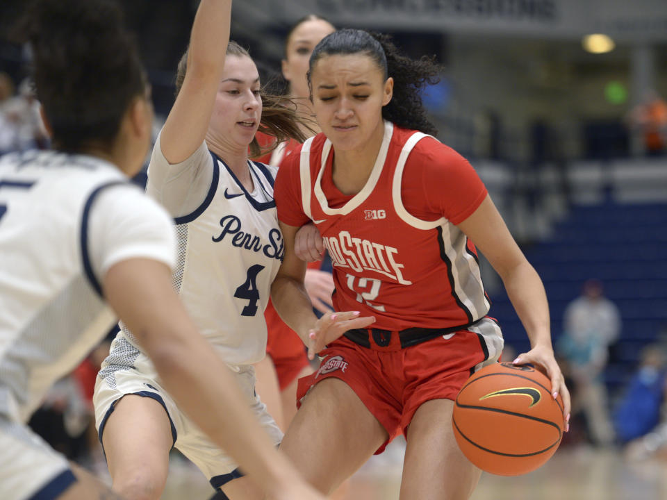 Penn State's Shay Ciezki (4) defends against Ohio State's Celeste Taylor (12) during the first half of an NCAA college basketball game Thursday, Feb. 22, 2024, in State College, Pa. (AP Photo/Gary M. Baranec)