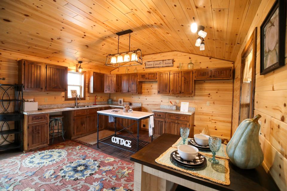 Inside the kitchen and dining area of an Amish Made Cabin.   The manufacturer in Shepherdsville is a family-owned-and-operated business that has been building modular cabins for nearly 16 years.  Each cabin is constructed at their manufacturing shop in Munfordville, then delivered to their destinations.
