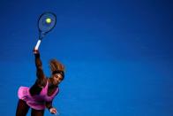 FILE PHOTO: Serena Williams of the U.S. serves to Ana Ivanovic of Serbia during their women's singles match at the Australian Open 2014 tennis tournament in Melbourne