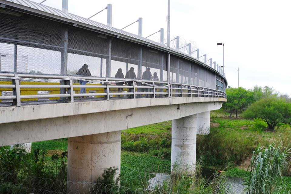 Pedestrians cross Gateway International Bridge on Monday, March 6, 2023, in Brownsville, Texas, into Matamoros, Mexico.