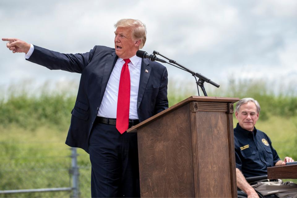 Former US president Donald Trump gestures as he speaks, flanked by Texas Governor Greg Abbott, during a visit to the border wall near Pharr, Texas on June 30, 2021. - Former President Donald Trump visited the area with Texas Gov. Greg Abbott to address the surge of unauthorized border crossings that they blame on the Biden administration's change in policies. (Photo by Sergio FLORES / AFP) (Photo by SERGIO FLORES/AFP via Getty Images)