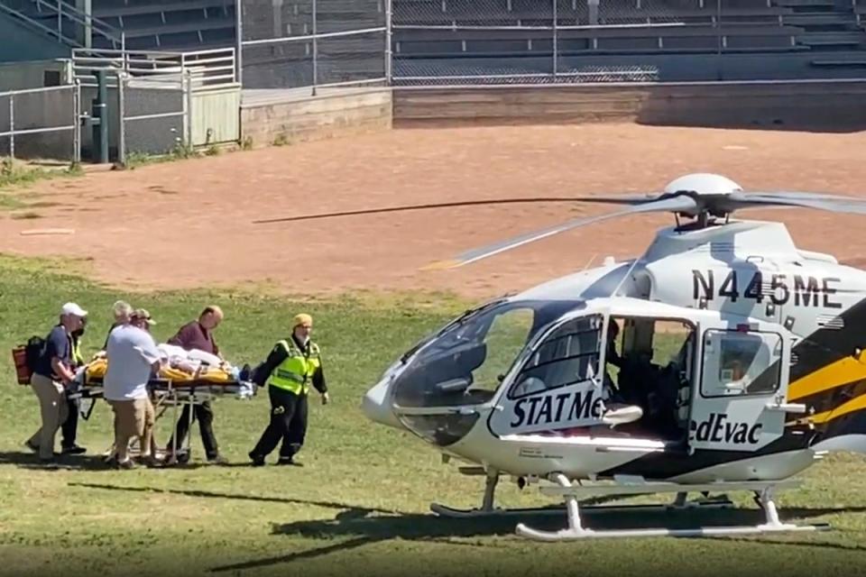 In this still image from video, author Salman Rushdie is taken on a stretcher to a helicopter for transport to a hospital (AP)