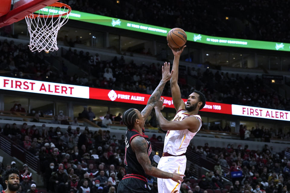 Cleveland Cavaliers' Evan Mobley (4) shoots over Chicago Bulls' DeMar DeRozan during the first half of an NBA basketball game Wednesday, Jan. 19, 2022, in Chicago. (AP Photo/Charles Rex Arbogast)