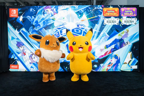 In this photo provided by Nintendo of America, Pikachu and Eevee stand in front of a PAX East banner themed to the Area Zero Treasures Part 2: Pokémon Scarlet or Pokémon Violet Indigo Disc DLC.