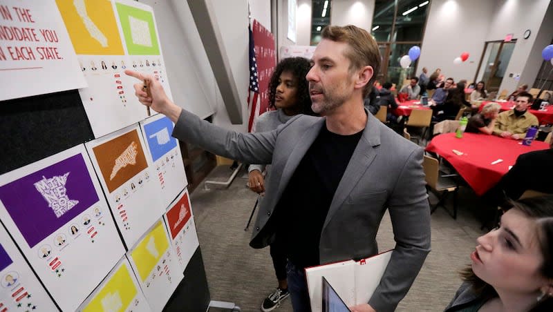 Hinckley Institute of Politics political science chair Brent Steele and his daughter Annabelle Steele compare predictions to state results as they roll in during a Super Tuesday election watch party at the Hinckley Institute of Politics in Salt Lake City on Tuesday, March 3, 2020.