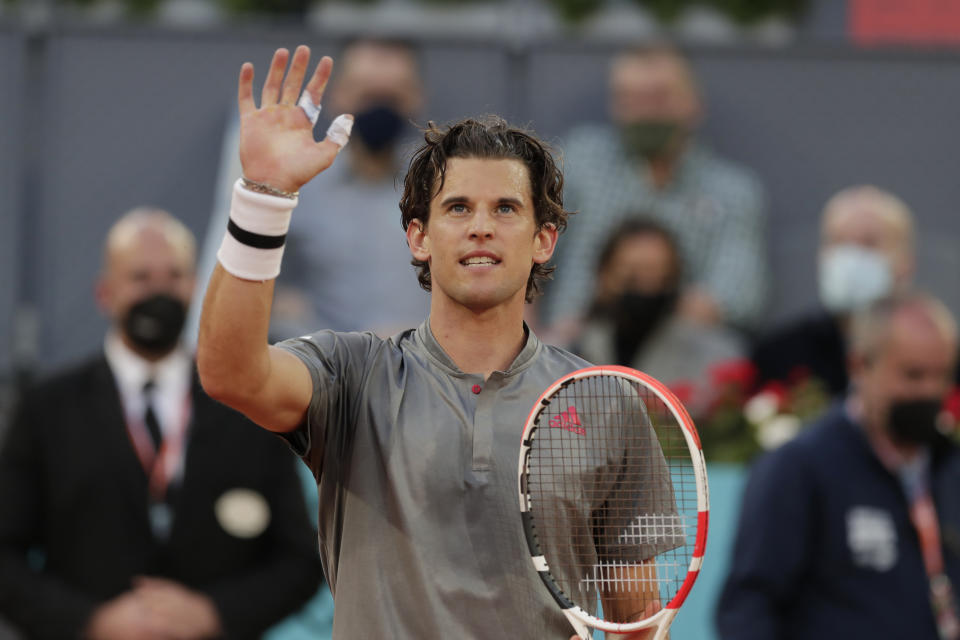 FILE - Dominic Thiem of Austria celebrates after defeating Marcos Giron of the U.S. 6-1, 6-3 during their match at the Madrid Open tennis tournament in Madrid, Spain, on May 4, 2021. Former finalist Dominic Thiem has announced that he is withdrawing from the Australian Open and will instead begin his 2022 season in South America. Thiem said he had a “slight set back” in his return from a wrist injury but is “now feeling well again.” Thiem was hurt in June while playing in the Mallorca Open and also missed Wimbledon and the U.S. Open this year. The Australian Open begins Jan. 17. Thiem reached the final in Melbourne in 2020, losing to Novak Djokovic. (AP Photo/Paul White, File)