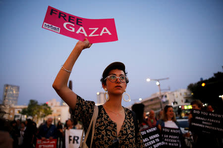 A protester holds a placard as she takes part in a demonstration calling for an end to Israel's policy towards Gaza and a boycott of the 2019 Eurovision Song Contest as the first semi final of the contest begins in Tel Aviv, Israel May 14, 2019. REUTERS/Corinna Kern