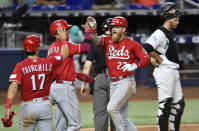 Cincinnati Reds' Jake Fraley, right front, celebrates his three-run home run with Jose Barrero and Stuart Fairchild (17) during the ninth inning of a baseball game against the Miami Marlins, Friday, May 12, 2023, in Miami. (AP Photo/Michael Laughlin)