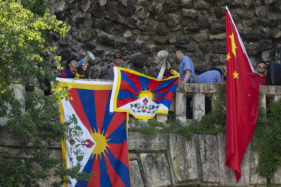 Tibetan protesters stretched Tibetan flags next to Chinese national flags in Gellert Hill against Chinese President Xi Jinping's visit to Budapest, Hungary, on Thursday, May 9, 2024. (AP Photo/Denes Erdos)