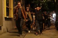 <p>People with their hands on their heads about 10 minutes after midnight as they leave from inside a police cordon after an attack in London, Sunday, June 4, 2017. Armed British police rushed to London Bridge late Saturday after reports of a vehicle running down pedestrians and people being stabbed nearby. (AP Photo/Matt Dunham) </p>