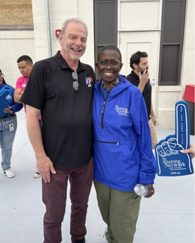 Organ donation recipients John Hunt (left), the New Jersey Jackals’ general manager, and E. Denise Peoples, who sang national anthem on opening day, at Hinchliffe Stadium on May 9.