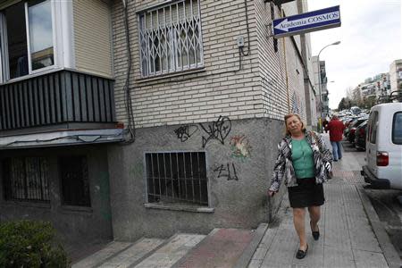 Carmen Collado walks to pick up her car near her home in Madrid March 14, 2014. Collado has laundered hospital linen for 11 years. REUTERS/Andrea Comas