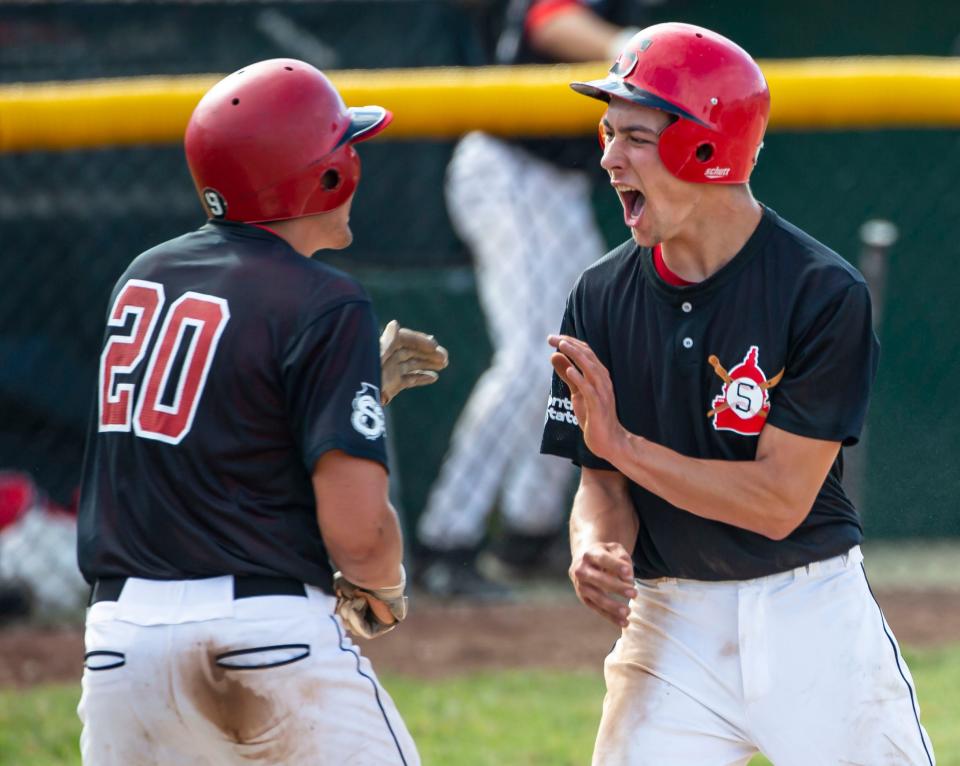 In this file photo, Springfield High's Cooper Burk (10) and Griffin Burk (20) celebrate after scoring a run against Jacksonville in the third inning during the Class 3A regional finals at Robin Roberts Stadium on Tuesday, June 8, 2021. [Justin L. Fowler/The State Journal-Register]